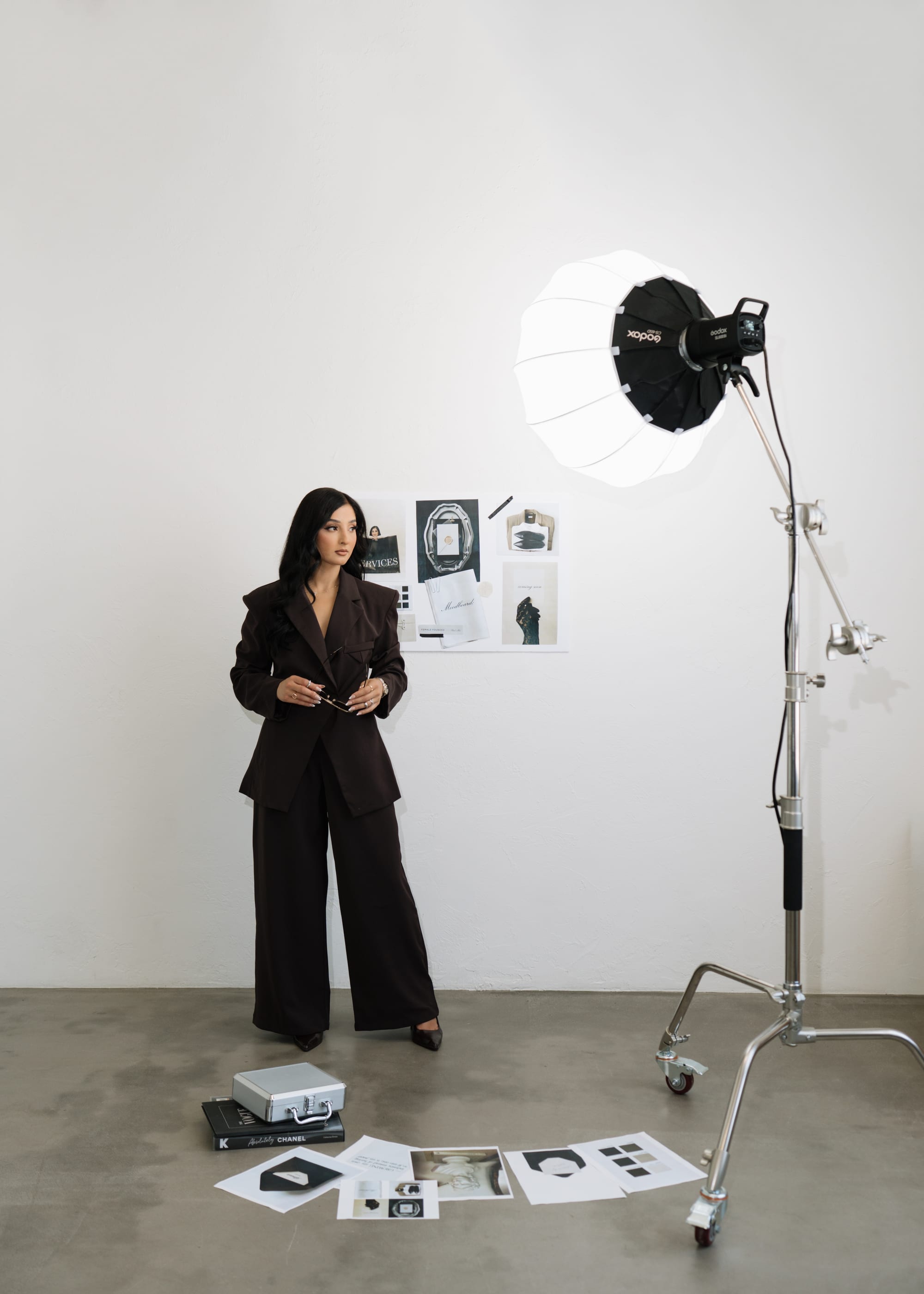 Elizabeth Valdovinos standing on the Texturah studio set beside a photography light and inspiration images